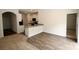Inviting living room featuring wood-look floors and an open floor plan concept to the kitchen at 8606 Highgate Dr, Charlotte, NC 28215