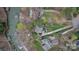 Aerial view of multiple homes showcasing their roof lines, landscaping, pools, and private docks at 8915 Linden Grove Ct, Sherrills Ford, NC 28673