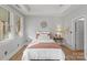 Inviting bedroom with soft bedding, accent mirror, and ample natural light at 8915 Linden Grove Ct, Sherrills Ford, NC 28673