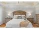 This primary bedroom features a decorative tray ceiling, warm paint colors, and attractive furnishings at 8915 Linden Grove Ct, Sherrills Ford, NC 28673