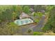 Aerial view of a large community pool, pool house, and adjacent parking lot surrounded by trees at 8915 Linden Grove Ct, Sherrills Ford, NC 28673