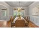 Bright dining room featuring hardwood floors, elegant lighting, and french doors at 8915 Linden Grove Ct, Sherrills Ford, NC 28673