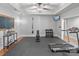 Well-equipped home gym with weights, treadmill, and mounted TV for a complete workout experience at 8915 Linden Grove Ct, Sherrills Ford, NC 28673