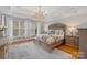 Bright main bedroom features hardwood floors, large windows, and elegant chandelier at 8915 Linden Grove Ct, Sherrills Ford, NC 28673