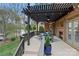 Covered patio with an outdoor dining area, a fireplace, and scenic views of the lush backyard at 8915 Linden Grove Ct, Sherrills Ford, NC 28673