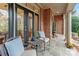 Inviting outdoor seating area with comfortable chairs and a small table on the covered porch at 8915 Linden Grove Ct, Sherrills Ford, NC 28673