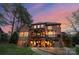 Stunning rear exterior view of a multi-story home with multiple patios and a beautifully landscaped yard at 8915 Linden Grove Ct, Sherrills Ford, NC 28673