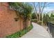 Charming walkway with landscaped greenery and a brick wall, leading to the home at 8915 Linden Grove Ct, Sherrills Ford, NC 28673