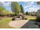 Large backyard with stone patio and sitting area, perfect for entertaining at 9422 Ridgeforest Dr, Charlotte, NC 28277