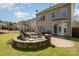 A backyard showcasing a stone firepit with seating, and partial fencing at 9422 Ridgeforest Dr, Charlotte, NC 28277