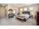 Comfortable bedroom with a upholstered bed, bench, neutral color scheme and lots of light at 9422 Ridgeforest Dr, Charlotte, NC 28277
