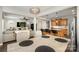 Open dining room with a modern chandelier adjacent to kitchen, living room and backyard at 9422 Ridgeforest Dr, Charlotte, NC 28277