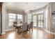 Bright dining room with an elegant chandelier and many windows with natural light at 9422 Ridgeforest Dr, Charlotte, NC 28277