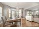 Open dining room with a modern chandelier, table for four, and great natural light at 9422 Ridgeforest Dr, Charlotte, NC 28277