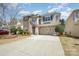 Charming two-story home featuring a stone and siding exterior, two-car garage, and well-maintained landscaping at 9422 Ridgeforest Dr, Charlotte, NC 28277