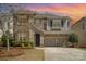 Charming two-story home featuring a stone and siding exterior, two-car garage, and well-maintained landscaping at 9422 Ridgeforest Dr, Charlotte, NC 28277