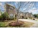 Charming two-story home featuring a stone and siding exterior, two-car garage, and well-maintained landscaping at 9422 Ridgeforest Dr, Charlotte, NC 28277