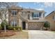 Charming two-story home featuring a stone and siding exterior, two-car garage, and well-maintained landscaping at 9422 Ridgeforest Dr, Charlotte, NC 28277
