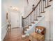 Inviting foyer featuring hardwood floors, staircase with iron spindles, and chair rail molding at 9422 Ridgeforest Dr, Charlotte, NC 28277