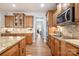 Charming kitchen featuring stone backsplash, granite counters, wood cabinets and stainless steel appliances at 9422 Ridgeforest Dr, Charlotte, NC 28277