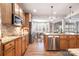 Modern kitchen featuring granite countertops, stainless steel appliances, and hardwood floors at 9422 Ridgeforest Dr, Charlotte, NC 28277