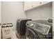 Modern laundry room with front-load washer, dryer, and storage cabinets at 9422 Ridgeforest Dr, Charlotte, NC 28277