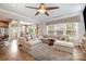 Bright, open living room with large sectional couch and many windows overlooking the front yard at 9422 Ridgeforest Dr, Charlotte, NC 28277