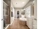 Spacious main bathroom with dual vanities, a soaking tub, and a separate shower at 9422 Ridgeforest Dr, Charlotte, NC 28277