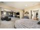 Large primary bedroom features a trey ceiling, sitting area, exercise bike, and access to the bathroom at 9422 Ridgeforest Dr, Charlotte, NC 28277