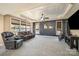 The main bedroom features a trey ceiling, seating area, exercise bike, and many windows at 9422 Ridgeforest Dr, Charlotte, NC 28277