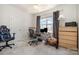 Bright office space featuring carpeted floors, a ceiling fan, and a large window view at 9422 Ridgeforest Dr, Charlotte, NC 28277