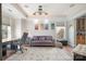 Comfortable office space with hardwood floors, sofa, and stylish lighting fixtures at 9422 Ridgeforest Dr, Charlotte, NC 28277