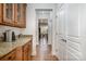 Convenient butler's pantry with granite countertops, custom cabinetry, and hardwood floors at 9422 Ridgeforest Dr, Charlotte, NC 28277