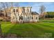 Charming two-story home with a lush green lawn, complemented by mature trees providing natural shade at 9849 Rich Hatchet Rd, Huntersville, NC 28078