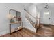 Welcoming foyer boasts new hardwood floors, console table and decor, staircase, and entry door at 9849 Rich Hatchet Rd, Huntersville, NC 28078
