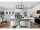 Modern kitchen features stainless steel appliances, an island with seating, and ample storage in white cabinets at 9849 Rich Hatchet Rd, Huntersville, NC 28078
