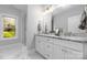 Elegant main bathroom features double vanity sinks, and a frameless glass shower for a clean and spa-like experience at 9849 Rich Hatchet Rd, Huntersville, NC 28078