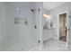 Modern main bathroom with a luxurious tiled shower, a frameless glass door, and stylish fixtures at 9849 Rich Hatchet Rd, Huntersville, NC 28078