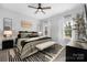 Serene main bedroom with natural light, plush bedding, and stylish decor, creating a relaxing retreat at 9849 Rich Hatchet Rd, Huntersville, NC 28078