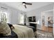 Comfortable main bedroom with large windows, plush bedding, and dark furniture, creating a modern relaxing space at 9849 Rich Hatchet Rd, Huntersville, NC 28078