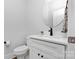 Elegant powder room boasts a modern vanity with marble countertop, black faucet, and round mirror at 9849 Rich Hatchet Rd, Huntersville, NC 28078