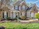Charming two-story brick home with well-maintained landscaping, inviting entrance and an attached garage at 1009 Summer Creste Dr, Indian Trail, NC 28079