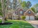 Charming brick home with well-manicured lawn, a three-car garage, and a welcoming front entrance at 1009 Summer Creste Dr, Indian Trail, NC 28079