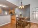 Bright kitchen with light wood cabinets and dining area featuring a wood table and chairs at 1009 Summer Creste Dr, Indian Trail, NC 28079