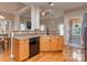 Functional kitchen featuring wood cabinets, laminate countertops and hardwood floors with backyard view at 1009 Summer Creste Dr, Indian Trail, NC 28079