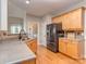 Well-equipped kitchen boasting wood cabinets, updated appliances, laminate countertops and hardwood floors at 1009 Summer Creste Dr, Indian Trail, NC 28079