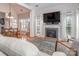 Cozy living room with fireplace, large windows, and comfortable seating area with area rug at 1009 Summer Creste Dr, Indian Trail, NC 28079