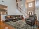 Bright and spacious living room with hardwood floors, comfortable seating, stairway and lots of sunlight at 1009 Summer Creste Dr, Indian Trail, NC 28079