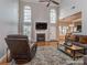 Cozy living room with vaulted ceiling, fireplace, hardwood floors and large windows for ample natural light at 1009 Summer Creste Dr, Indian Trail, NC 28079