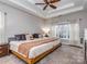 Spacious main bedroom with tray ceiling, large bed, and ample natural light from the window at 1009 Summer Creste Dr, Indian Trail, NC 28079